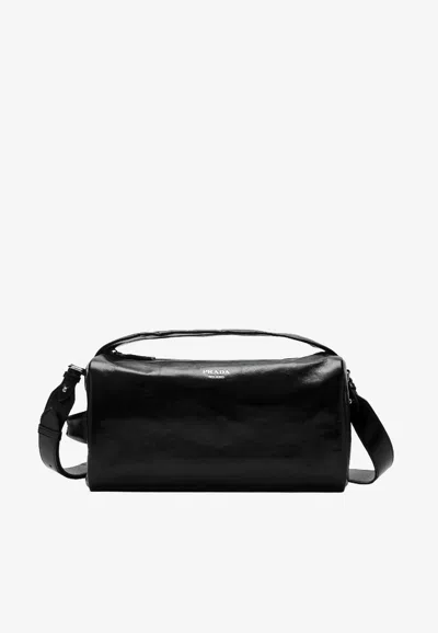 Prada Stamped Logo Glossy Leather Messenger Bag In Black