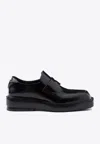 Prada Triangle Patch Leather Loafers In Black