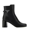 Prada Triangle-plaque Ankle Boots In Black