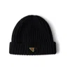 Prada Triangle-logo Ribbed Beanie In Black