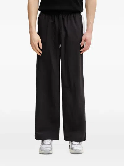 Puma T7 Logo-print Side-stripe Track Pants In Schwarz