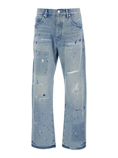 PURPLE BRAND BLUE JEANS WITH LOGO PATCH ON THE REAR AND ALL-OVER RIPPED DETAILS IN DENIM MAN