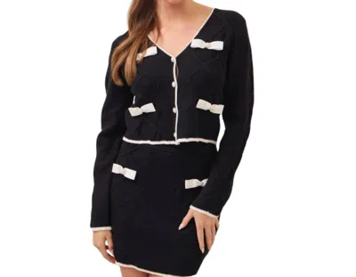 Rivir Cable Knit Cardigan With Contrast Bows And Pearl Flowered Buttons In Black
