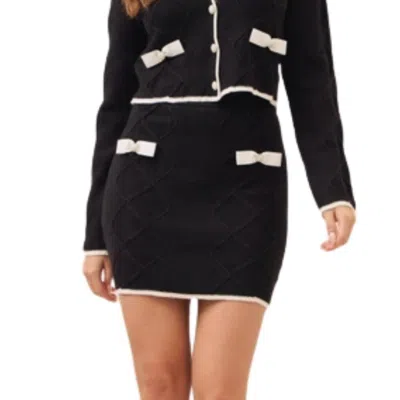 Rivir Cable Knit Mini Skirt With Contrast Bows And Pearl Flowered Buttons In Black