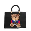 Rue Madame Textured Leather Tote Bag With Teddy Bear Applique In Black