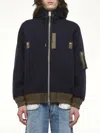 Sacai Hooded Knitwear With Ribbed Hem In Blue