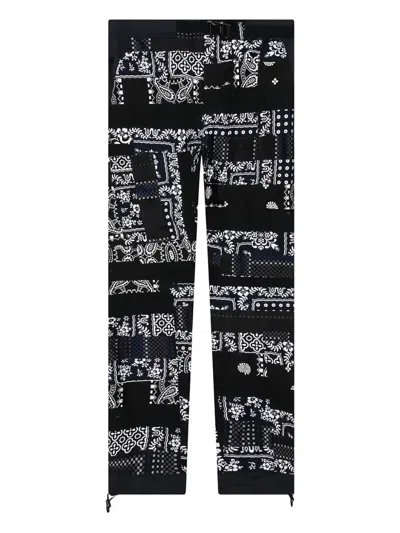 Sacai X Hank Willis Thomas Patchwork Trousers In Black