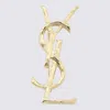 Saint Laurent Gold Metal Brooches In Gold