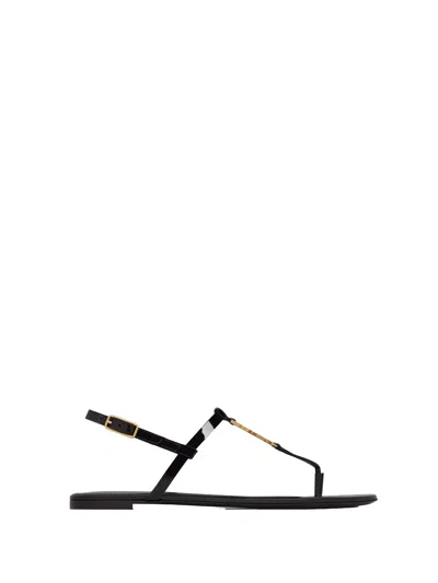 Saint Laurent Cassandra Flat Sandals In Patent Leather, Black With Gold Monogram, Deco