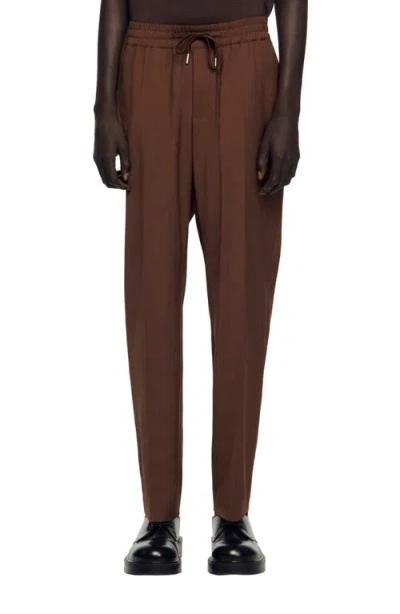 Sandro Elasticated Straight-leg Trousers In Brown