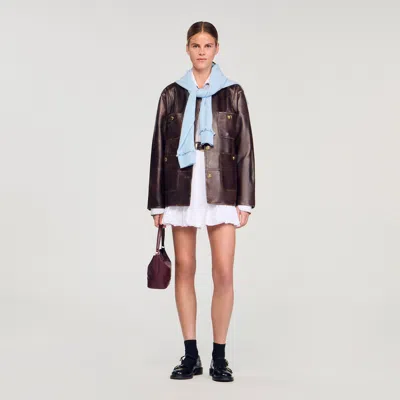 Sandro Long Distressed Leather Jacket In Brown