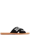 Schutz Logo-print Flat Leather Slides In Schwarz