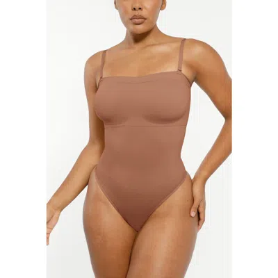 Shapellx Skin Flow Strapless Sculpt Thong Bodysuit In Brown