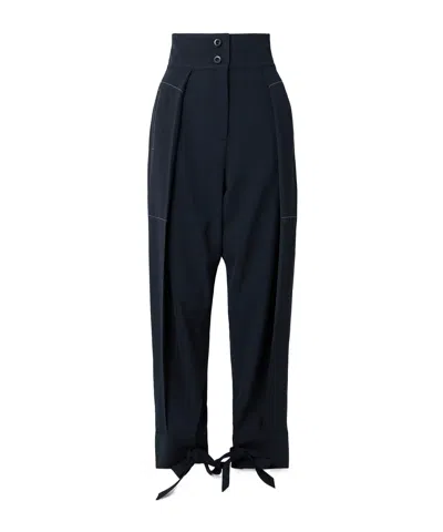Sharon Wauchob Arch Topstitched Paneled Pleated Wool-twill Tapered Pants In Blue