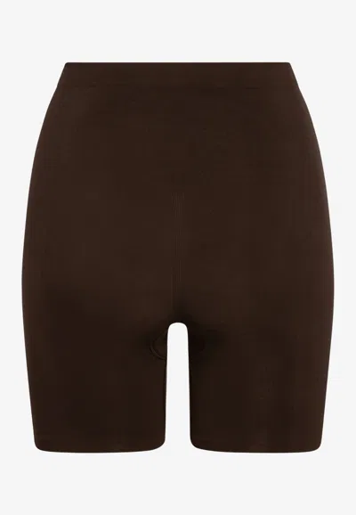 Skims Seamless Sculpt Mid-thigh Shaping Shorts In Brown