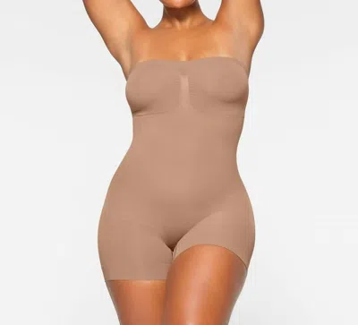 Skims Seamless Sculpt Strapless Mid Thigh Bodysuit In Sienna In Gold