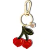 Solar Eclipse Cherry Hearts Key Chain In Gold