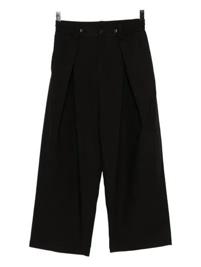 Songzio Homme Trousers In Black