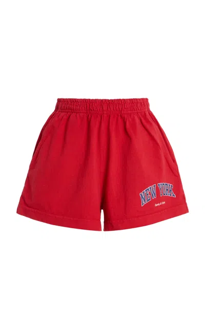 Sporty And Rich New York Ivy Cotton Disco Shorts In Red