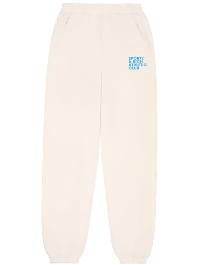 Sporty And Rich Slogan-print Cotton Track Pants In Cream