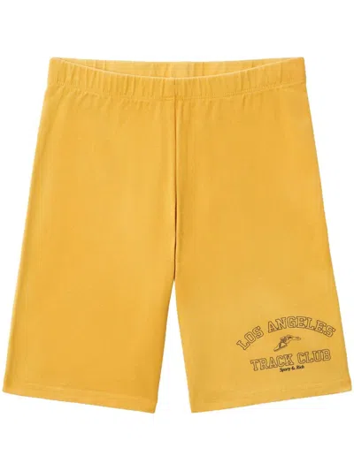Sporty And Rich Track Club Cotton Shorts In Gold