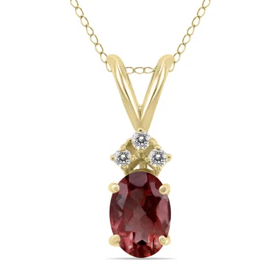 Sselects 14k 6x4mm Oval Garnet And Three Stone Diamond Pendant In Red