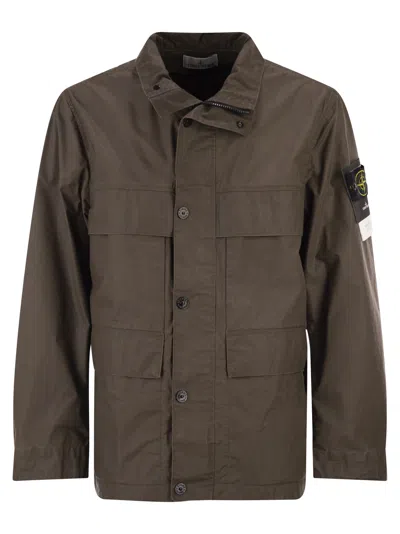 Stone Island Field Jacket With Pigmented Wax Coating In Brown