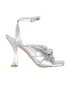 Stuart Weitzman Heeled Sandals With Knot Detail And Metallic Finish In White