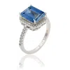 Suzy Levian Golden Sterling Silver Large Emerald-cut Green And White Cubic Zirconia Halo Ring In Blue