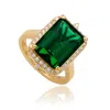 Suzy Levian Rose Sterling Silver Large Emerald-cut Red Cubic Zirconia And Baguette White Cubic Zirconia Halo Rin In Gold