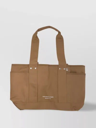 The North Face Double Handle Tote Bag With Riveted Accents And Side Pockets