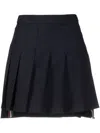 THOM BROWNE NAVY BLUE PLEATED SKIRT WITH RWB STRIPE AND HIGH-LOW HEM