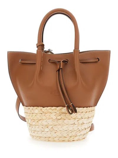 TOD'S BROWN HANDBAG WITH BUCKET DESIGN AND METALLIC TIMELESS T PENDANT