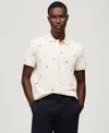 Tommy Hilfiger Men's Regular Fit Allover Flag Polo Shirt In Ivory Petal