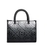 Tory Burch T Monogram Embossed Tote In Black