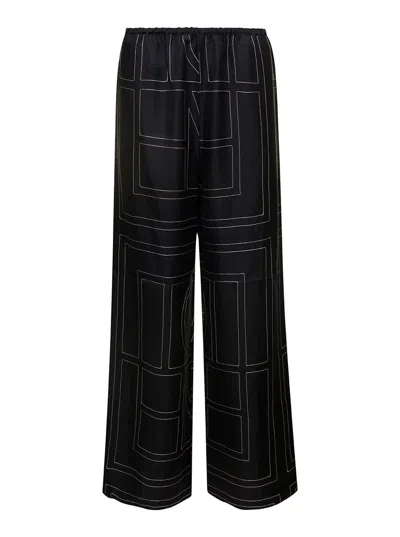 Totême Black Loose Pants With Monogram Print In Silk Woman In Multi