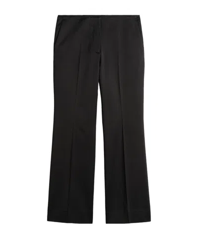 Totême Kick Flare Raw Edge Trousers In Blue