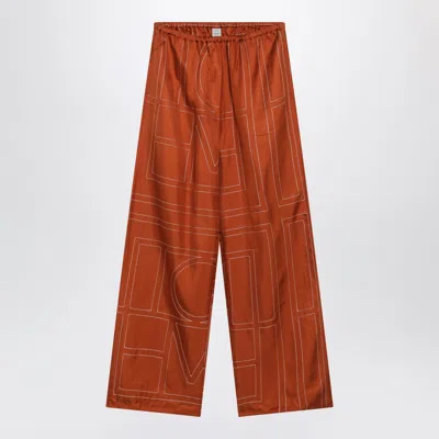 Totême Toteme Monogram Silk Pajama Trousers In Terracotta In Orange
