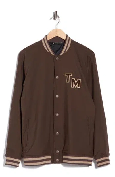 Travismathew Touch Down Varsity Jacket In Chocolate Brown