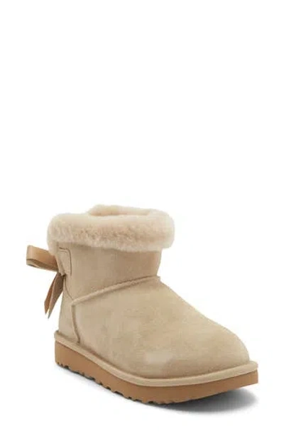 Ugg ® Mini Bailey Bow Faux Shearling Boot In Mustard Seed