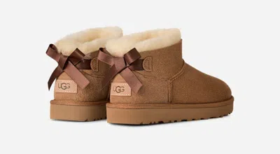 Ugg ® Women's Ultra Mini Bailey Bow Sheepskin Classic Boots In Chestnut In Brown