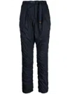 Undercover Logo-tag Buckle-fastening Tapered Trousers In Blue
