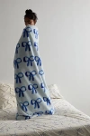 Urban Outfitters Harper Faux Fur Printed Throw Blanket In Bows At  In Blue