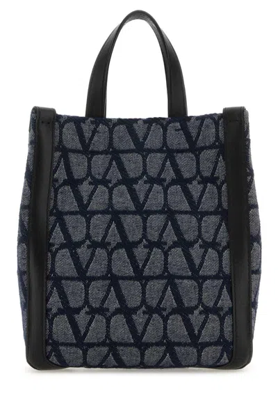 Valentino Garavani All-over Logo Patterned Top Handle Bag In Melangedenimnero
