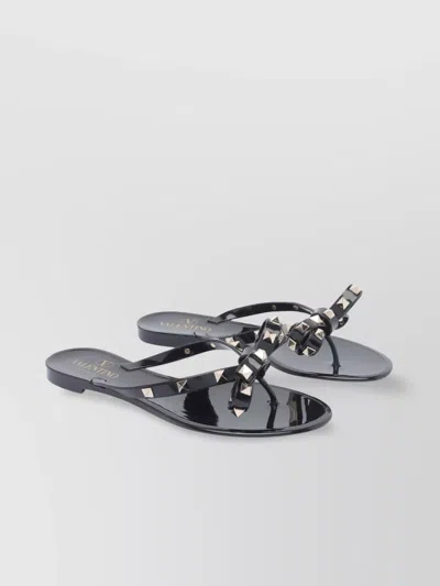 VALENTINO GARAVANI BOW DETAIL FLAT SANDALS WITH STUDDED EMBELLISHMENTS