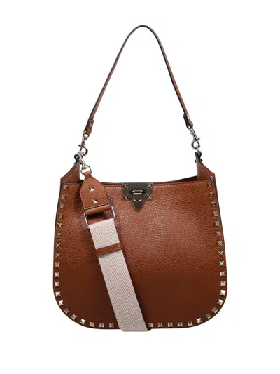 Valentino Garavani Rockstud Logo Printed Shoulder Bag In Brown