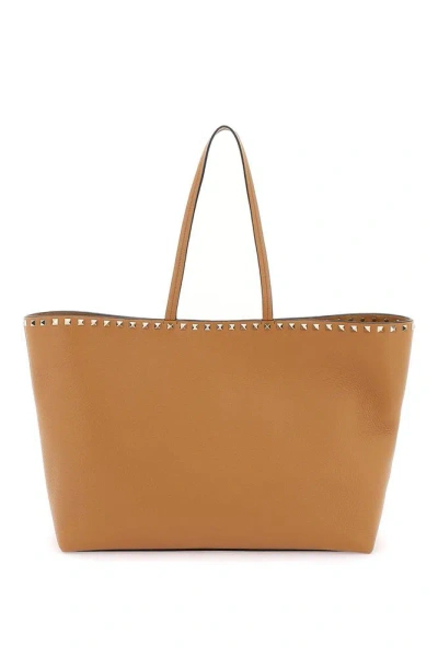 Valentino Garavani Rockstud Top Handle Bag In Orange