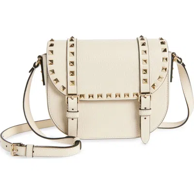 Valentino Garavani Small Rockstud Saddle Crossbody Bag In Light Ivory