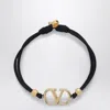 Valentino Garavani Vlogo Signature Bracelet In Black And Gold Women