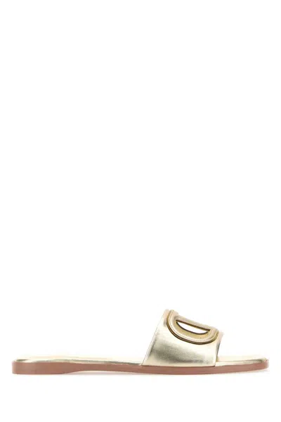 Valentino Garavani Gold Vlogo Cutout Laminated Nappa Leather Sandals In Platinum Antique Brass